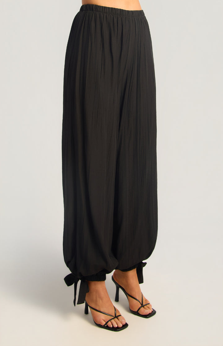 Textured balloon hem pants in black, front three-quarter view