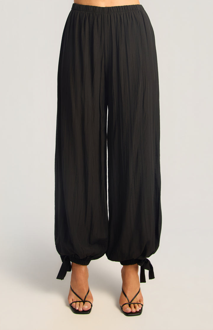 Textured balloon hem pants in black, front view