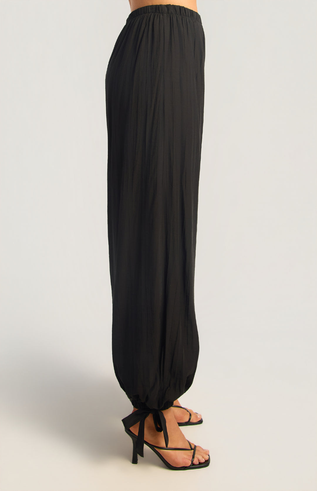 Textured balloon hem pants in black, side view